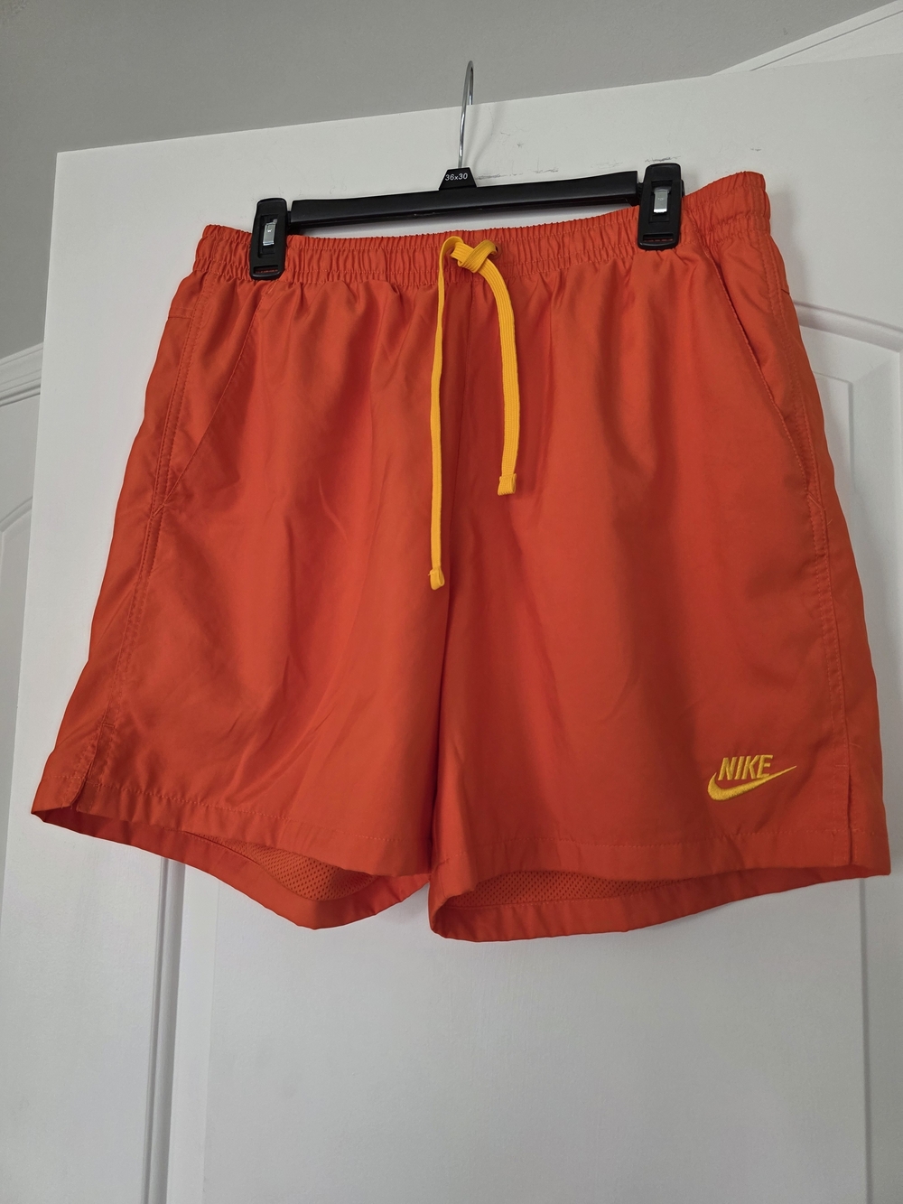 Nike Men's Orange Athletic Shorts with Yellow Drawstring and Logo
